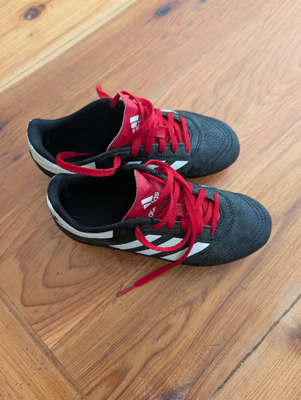 Adidas Kids Black Soccer Cleats with Red Laces and White Stripes